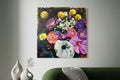 Floral painting above a green sofa in a living room setting